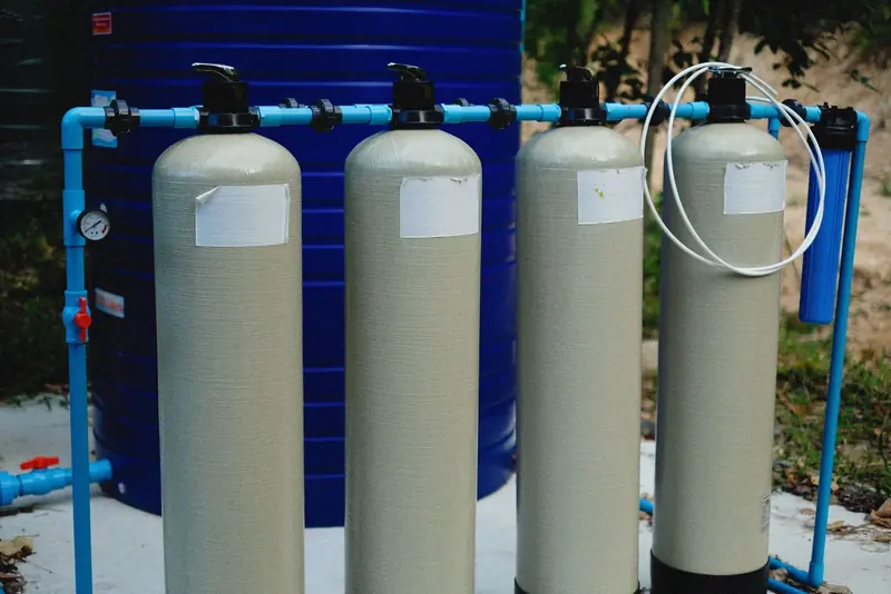 Whole-house water filtration system with large filter tanks