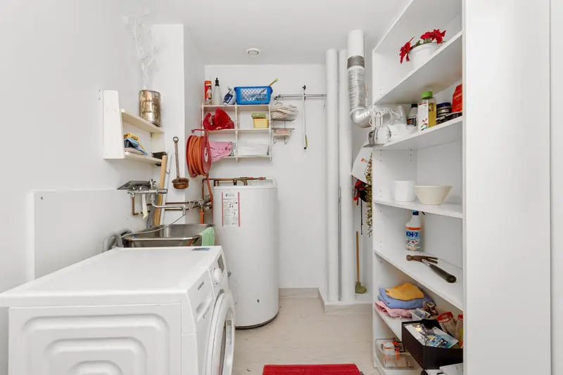 Tank-style water heater installed in a home utility closet